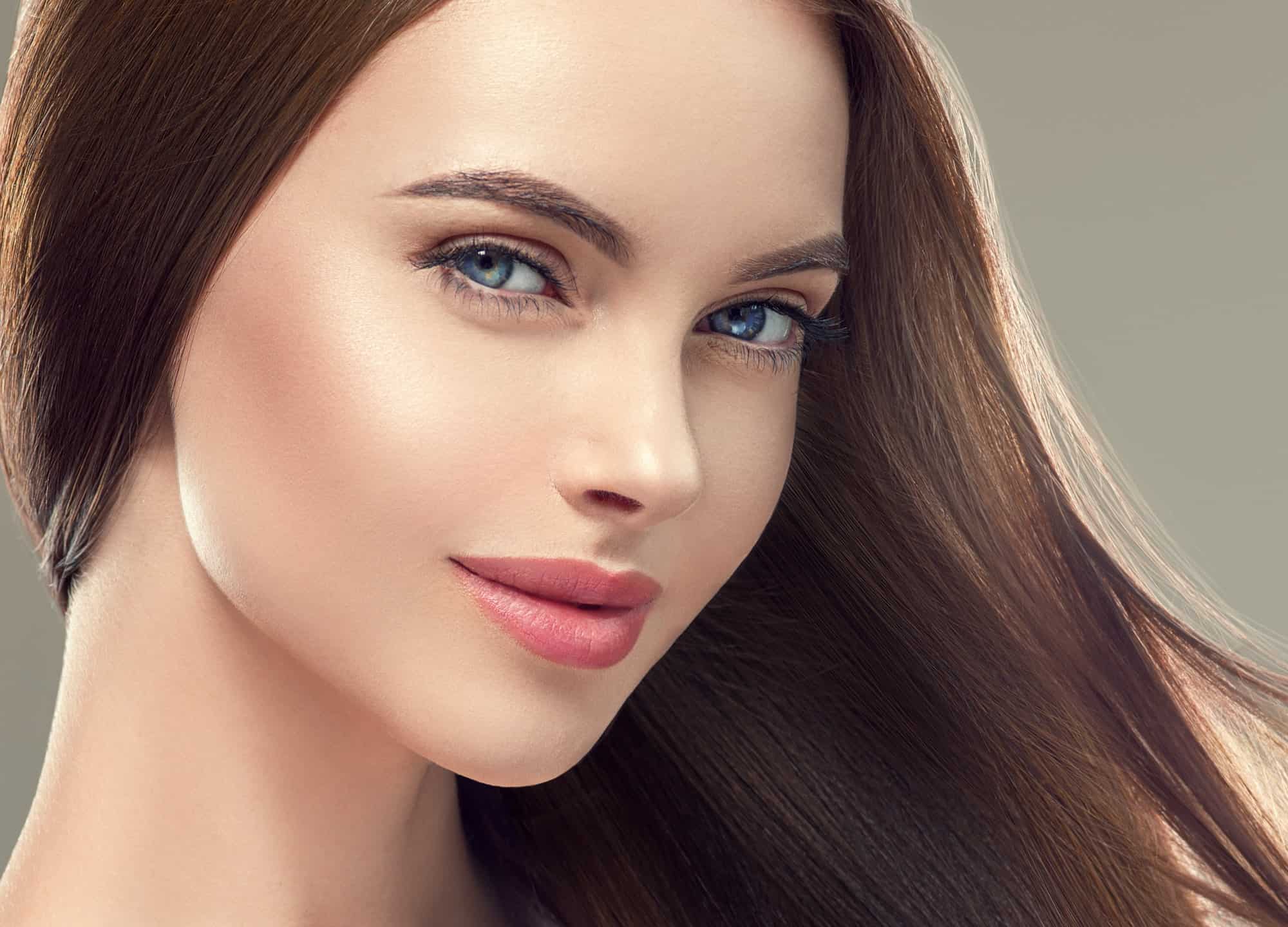 Woman with long smooth hair beautiful hairstyle fashion make up